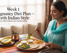 North Indian woman in early pregnancy eating a healthy meal of roti, dal, sautéed spinach, curd, and fresh fruits at a sunlit dining table, without a visible baby bump.
